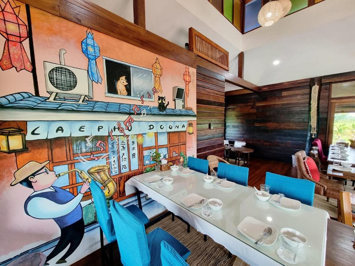 Doona restaurant dining room with a hand-painted kitchen mural