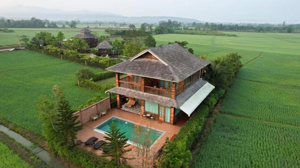 Aerial view of Doona Resort surrounded by Mae Taeng rice fields